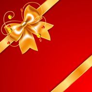 Golden bow of silk ribbon isolated on red background