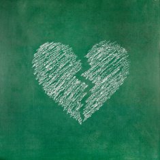 Tear heart shape on blackboard