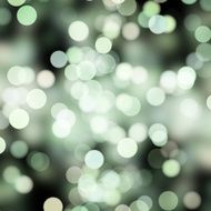blurred white and green dots on black