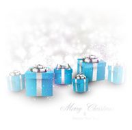 Winter background with blue christmas gifts