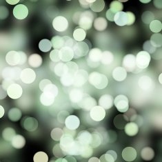 blurred white and green dots on black
