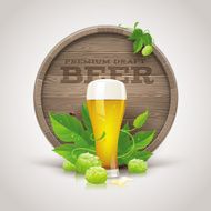 Still life with wooden cask beer glass and ripe hops