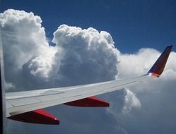 airplane wing in white clouds