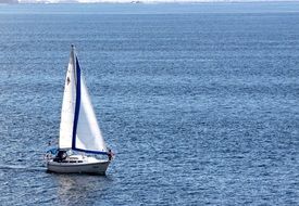 person on sailboat at blue sea