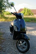 black scooter vespa