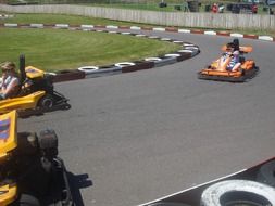 children on the colorful go-karts on the track