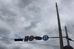 traffic lights and signs on wire above road