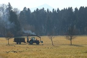 tractor rides on a green field