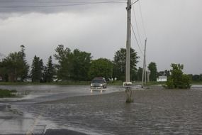 car rides on a flooded street