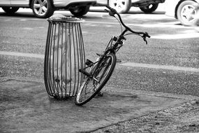 bicycle at trash bag holder on street