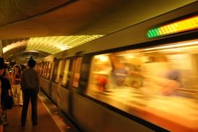 people at moving train in subway, usa, washington