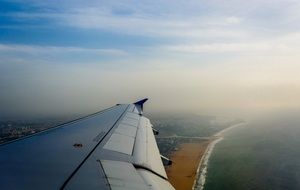 airplane wing view above the ground landscape from the window