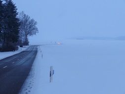 snow covered winter road in the fog