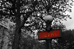 Metro sign on a street lamp