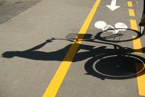 the shadow of the cyclist on the bike path