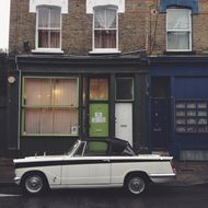 black and white vintage convertible in the street