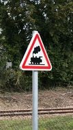 train, traffic sign in front of railway