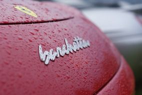 logo on red cars close up