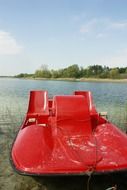 red catamaran on the lake