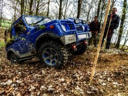 blue jeep is riding off-road