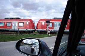 cars miss a train at a railway crossing