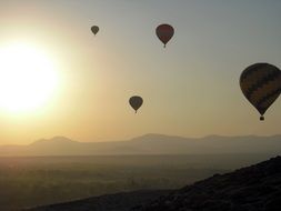 balloons in the sky during sunset