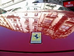 reflection of the building on the hood of a car