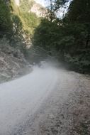 cars dust gravel road