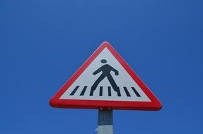 pedestrian crossing, traffic sign on pole at sky