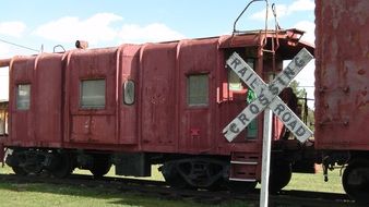 red train at the railway crossing