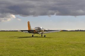 a small plane in a green field