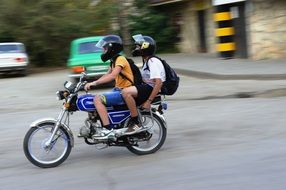 two guys is riding a motorcycle