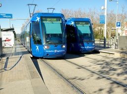 blue trams on rails