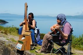musicians play instruments near the reservoir