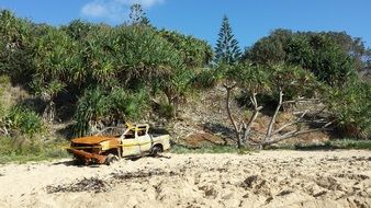 rusty car on the beach