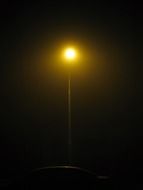 silhouette of a street lamp in the dark
