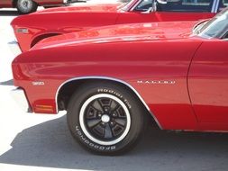 red Chevrolet Malibu in the parking lot on a sunny day