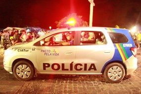 police car on the background of the crowd in Brazil