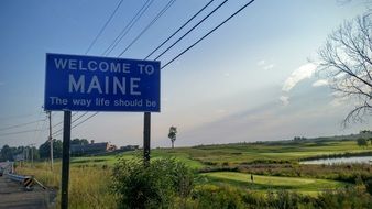 blue welcome to maine road sign