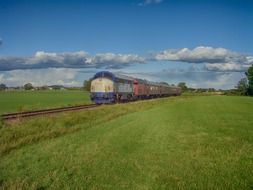 train among the green fields of sweden