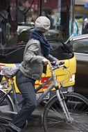 girl on a bicycle near the tram