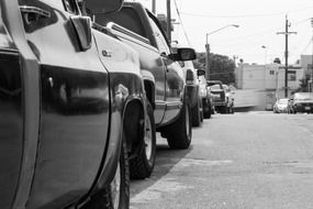cars on the street in black and white background