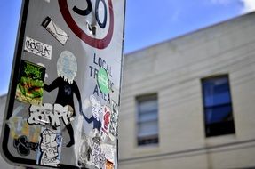 stickers on a street sign