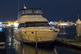 white yacht on the pier at night