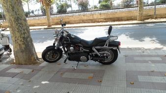 Motorcycle in shadow in the street