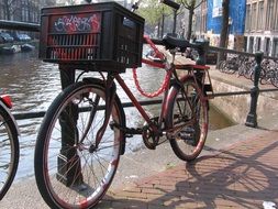 red bike by the canal in amsterdam