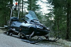 snowmobile on the road near the forest