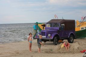 kids and purple jeep on the beach