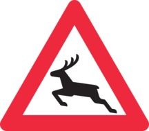 black deer on the road sign