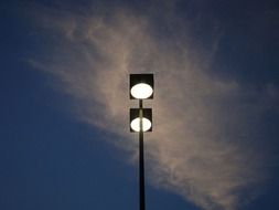 street lamp with light at dusk